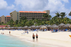 Clarification on visitors with property in Aruba policy