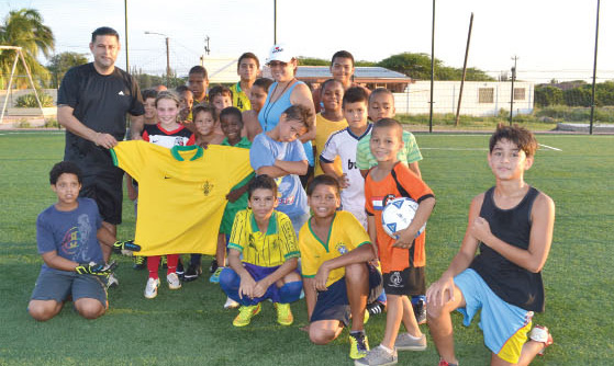 brings joy and encouragement to the little soccer players of Aruba