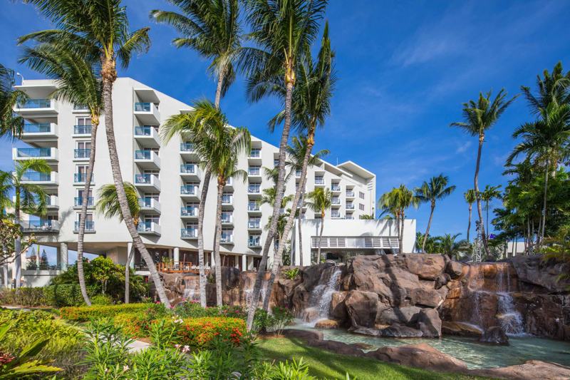 Palm-trees-and-pool-view-with-rocky-waterfall-at-the-hilton-aruba-caribbean-resort-and-casino